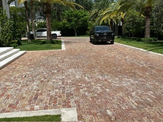Chicago brick driveway with a keystone border at a landscaped South Florida home
