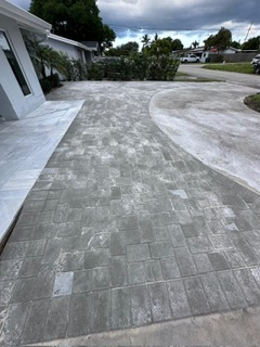 Gray paver driveway with a curved edge