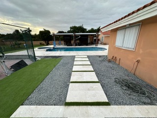 Modern stepping-stone path through decorative gravel and turf