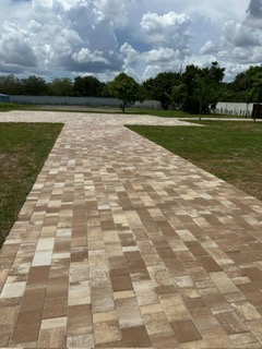 Multicolor paver driveway across a Florida lawn
